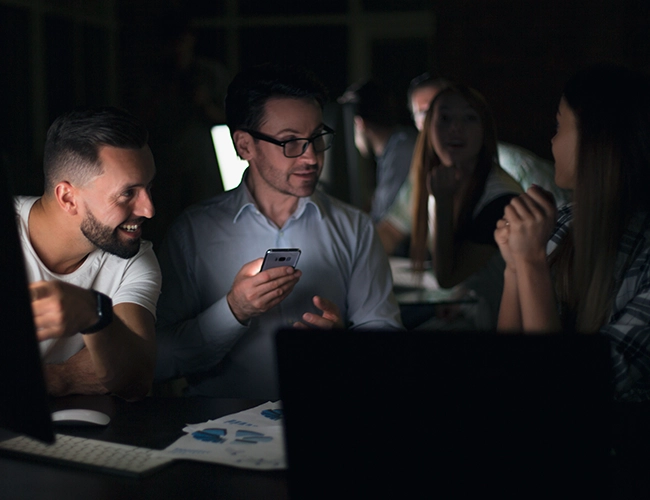 Group of people talking to one another with mobile phones